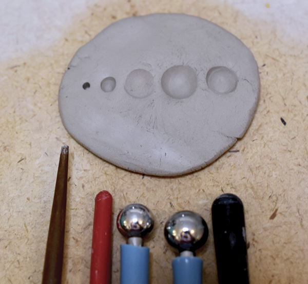 1 Use various found implements to create texture patterns in clay.