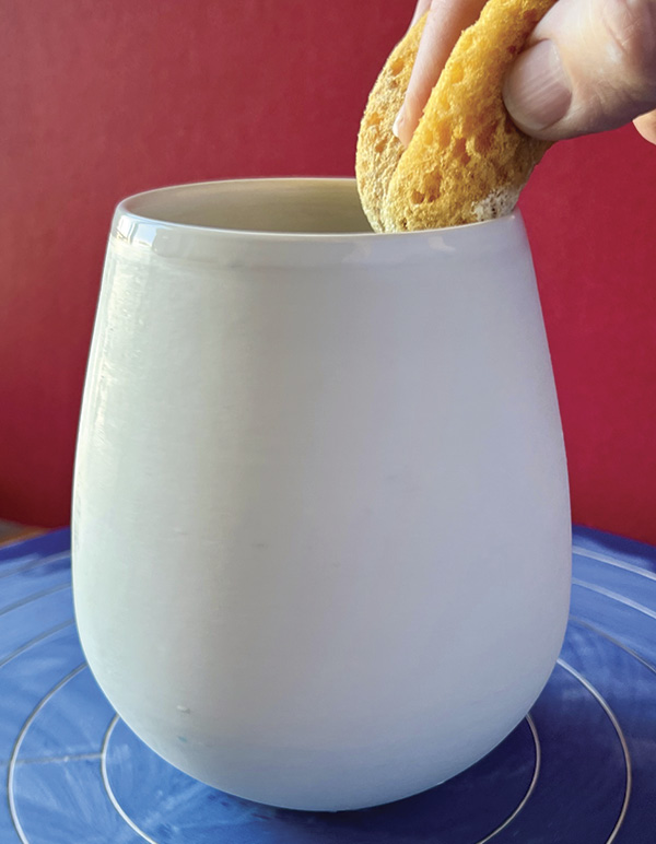 4 Smooth the rim with a sponge while spinning the piece on a banding wheel.