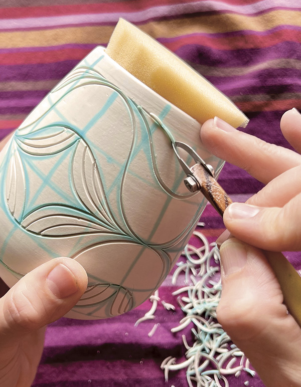 9 Following the lines drawn in food coloring, carve the design into the surface.