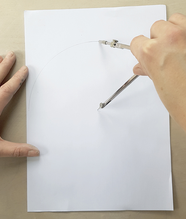 1 Begin making your cardboard tile template by drawing a large circle with  a compass.