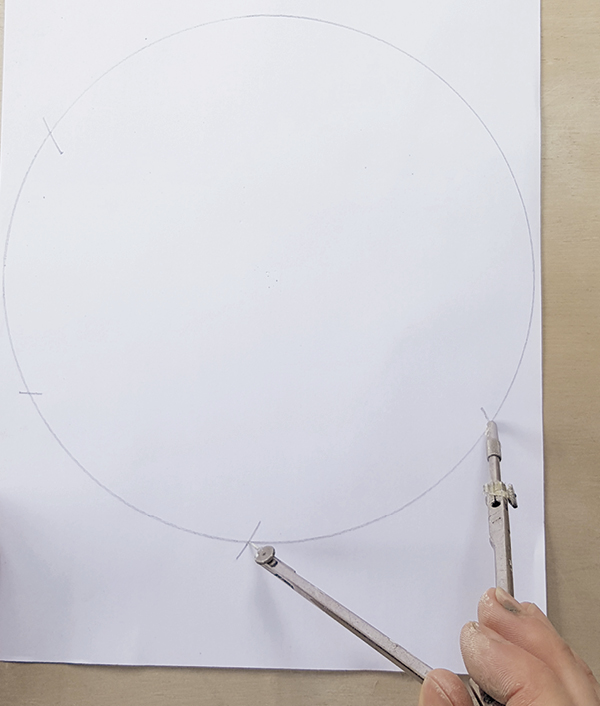 2 Without adjusting your compass, mark six points around the circumference of the drawn circle.