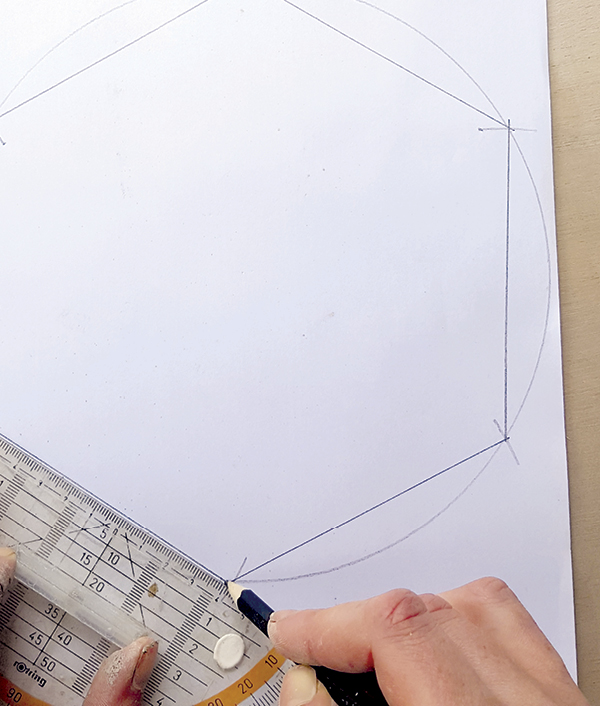 3 Using a ruler or straight edge, connect adjacent marks along the circle edge to create a hexagon. Cut out and set aside.