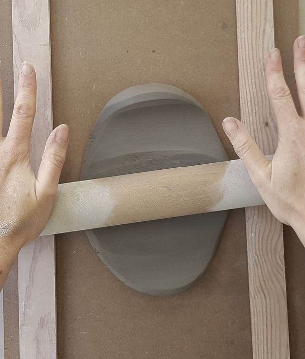 4 Roll out a ½-inch-thick slab of clay using a rolling pin and two thickness strips to ensure even thickness.