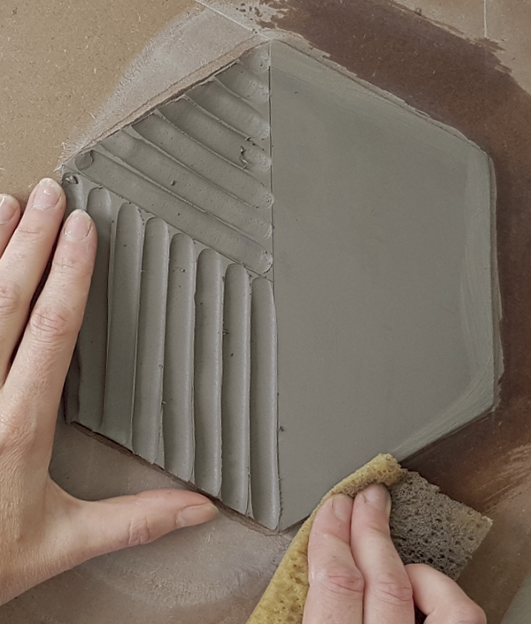 11 Sponge the carved lines and the tile’s edges to smooth and eliminate any sharp edges that may chip.