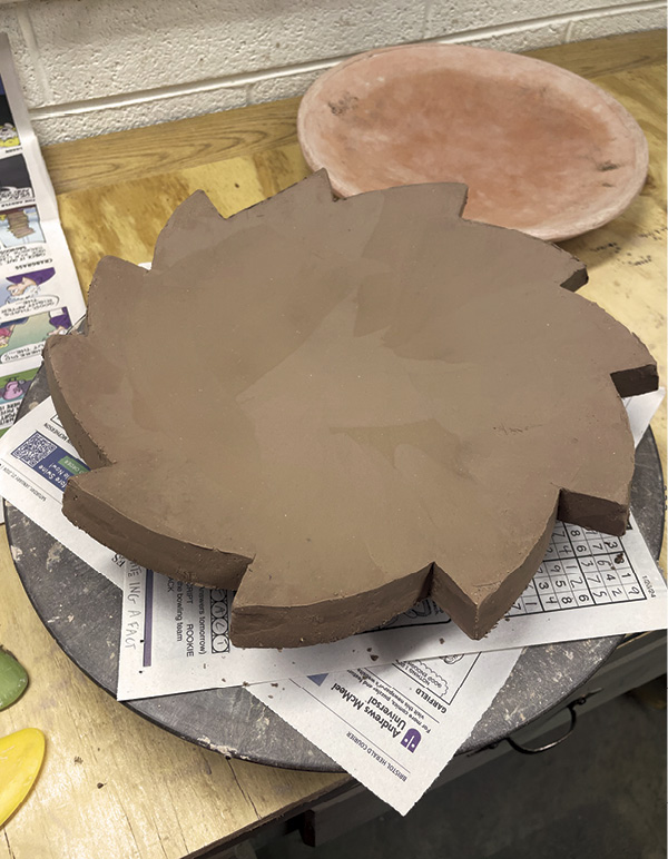 6 Flip right side up and use a smooth plastic rib to compress the surface.