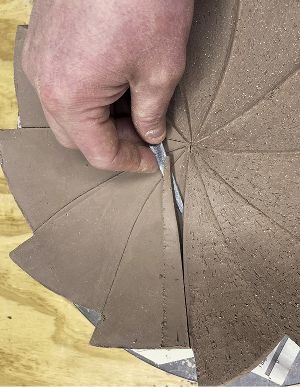 8 Using a vertical cut as a guide, cut a wedge along the length of each section.