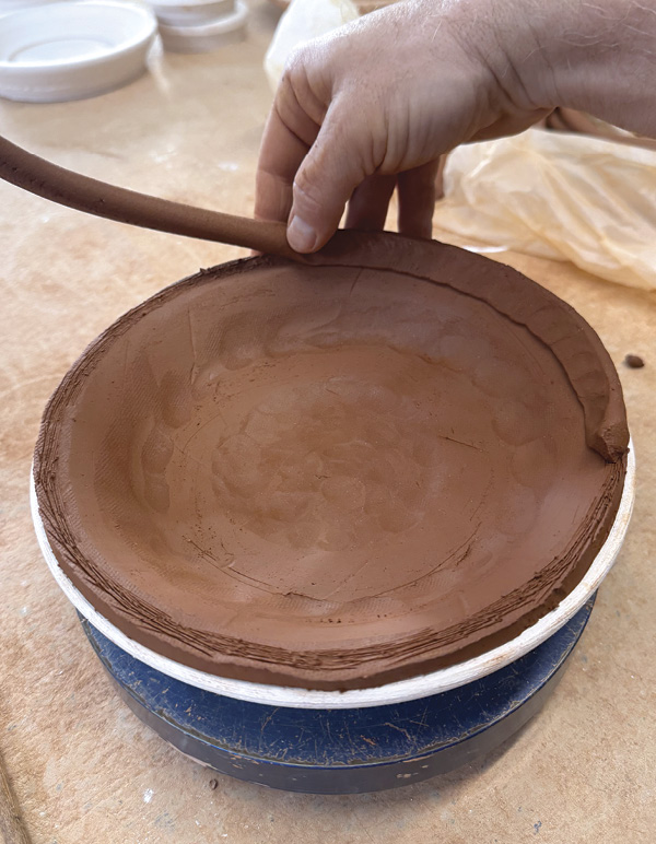 3 Score the coil, place a slab over it, then score the circumference of the edge.