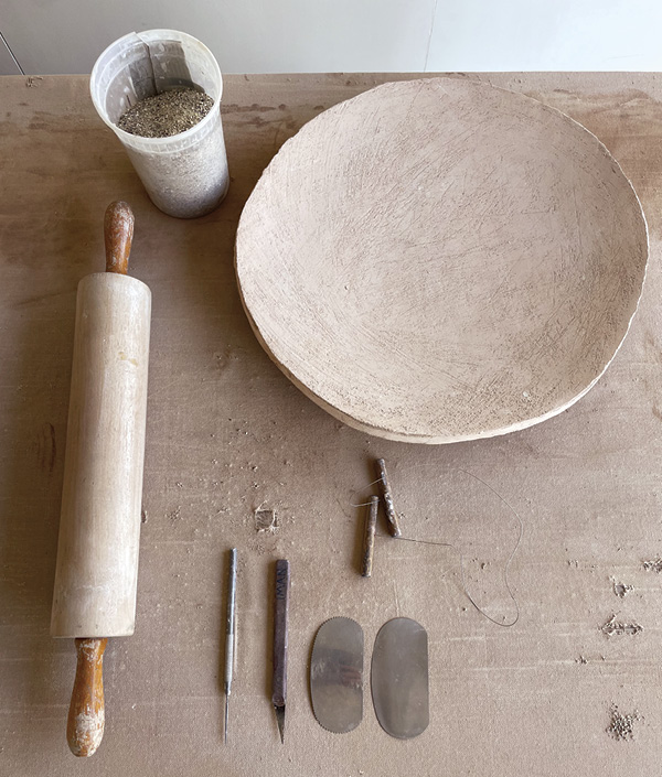 1 Tools and materials needed: grog, slump mold, rolling pin, needle tool, knife, serrated rib, metal rib, wire cutter.