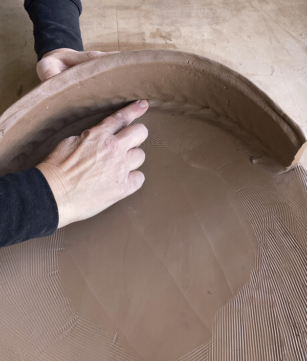 6 Score, slip, and add the walls, using the extra thick wall and base to compress them securely into one another.