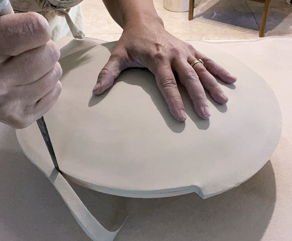 3 Smooth, compress, and texturize the bottom of the plate before trimming any excess off the edge.