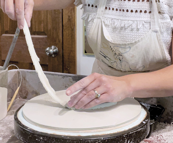 6 Place and secure the plate and mold on a wheel and score a circle for the foot. Add the foot using the circle as your guide.