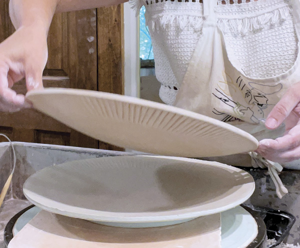 8 Put a bat on the foot (this one is a plaster rectangle for no good reason) and lift the bisque hump mold off of the plate.
