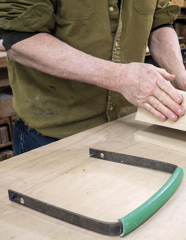 2 This slab-cutting harp is made from bent steel, wire, and cut garden hose.