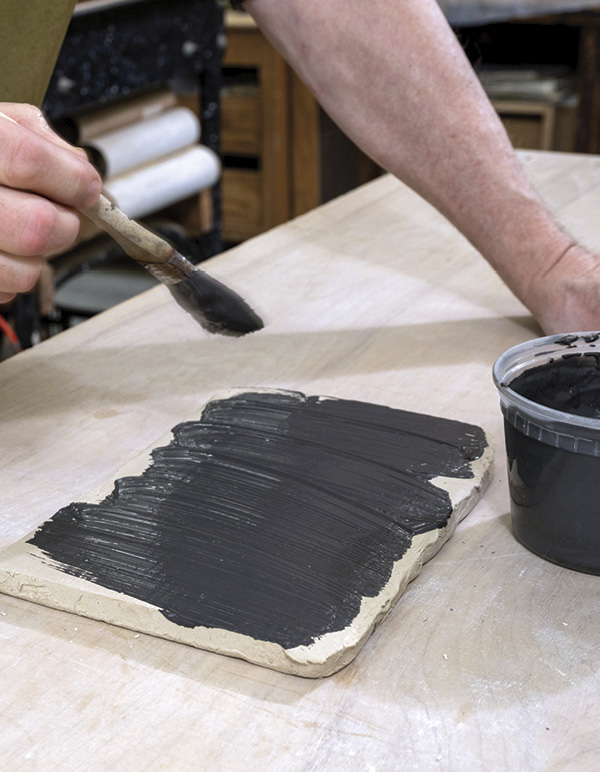 4 Apply a contrasting slip to one of the ½-inch-thick slabs.