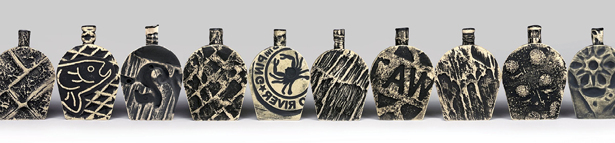 An assortment of Frank James Fisher's textured flasks.