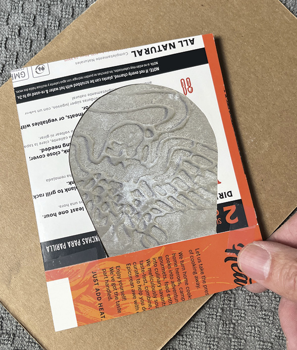 8 Determine the exact positioning of the impression by looking through the flask cut-out template.