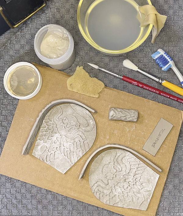 12 All the parts are ready to be assembled. Score the base and flask panel, add a generous bead of slip.