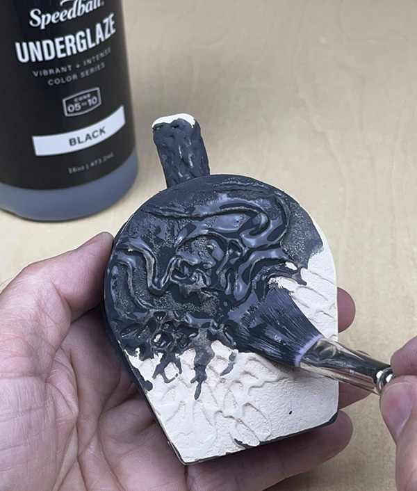 20 Next, cover the exterior with a black underglaze. Be sure to get underglaze into the texture’s crevices.