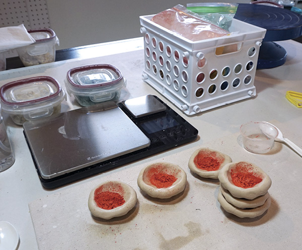 1 Divide stain into small pinch pots, spray with water, stack, and wedge thoroughly.