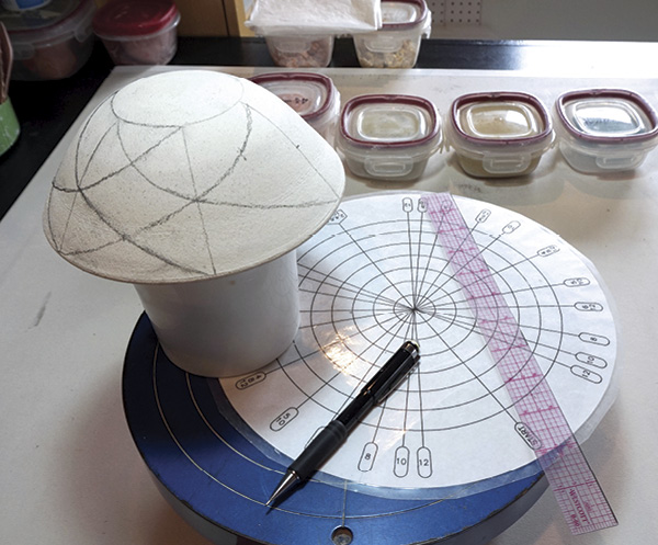 2 Use a dividing wheel and a ruler to mark out your pattern on a hump mold.