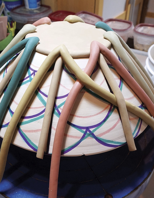 7 Weave coils, working around the form in one direction. Score each connection.