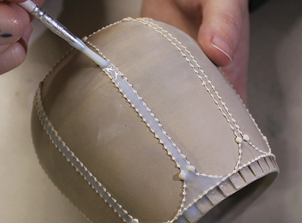 4 Use a paintbrush to apply wax to areas of the piece where lace will not be visible.