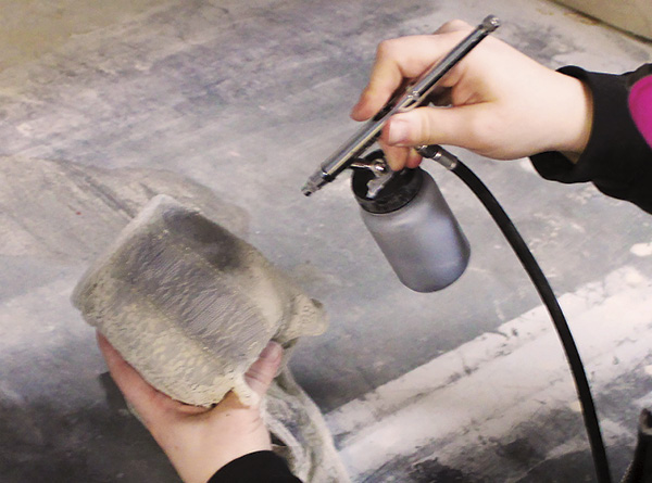 5 Using an airbrush, spray underglaze through lace onto a piece. Always be sure to wear a respirator during this process.