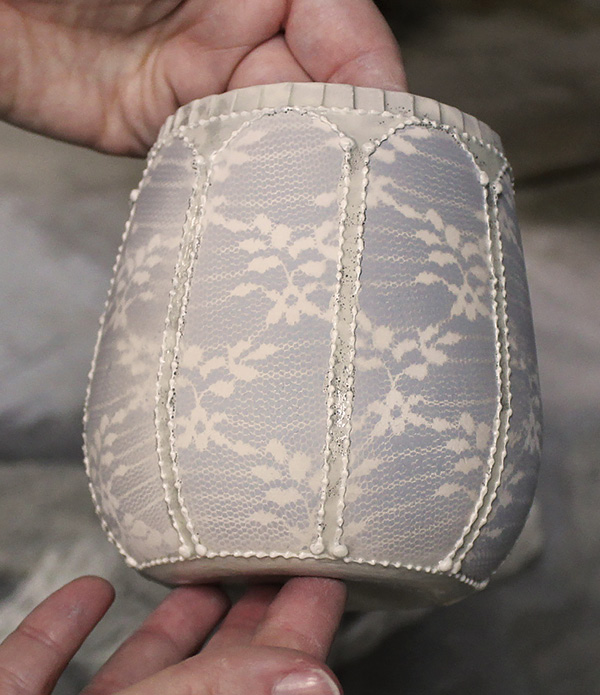 6 Remove the lace to see the pattern transferred to the greenware cup.