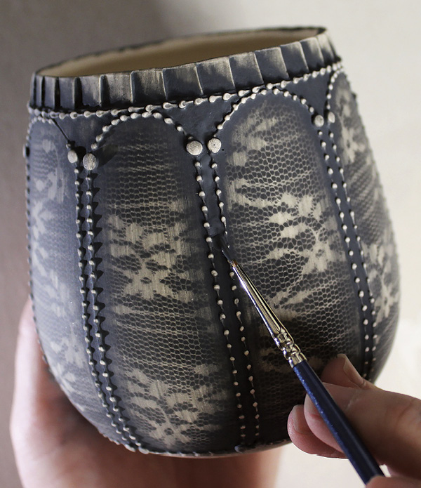 8 Reapply the black engobe to any necessary areas with small paintbrush.