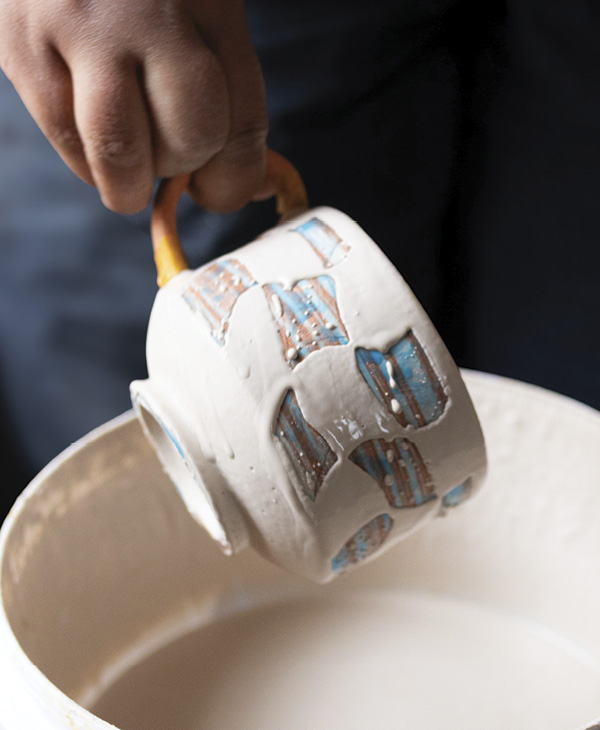11 Vigorously shake off the excess to remove glaze from the waxed areas.