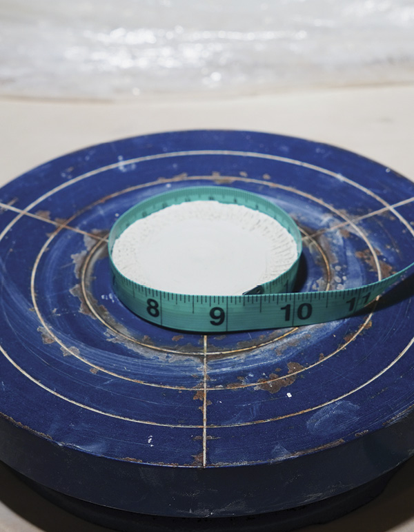 2 Score, measure the circumference, then cut a coil to that length.