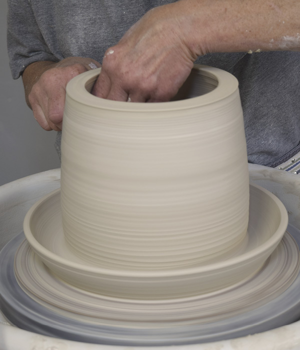 9 Smooth the connection point on the inside and pull the wall a bit taller, thinning the clay at the top of the added cylinder.