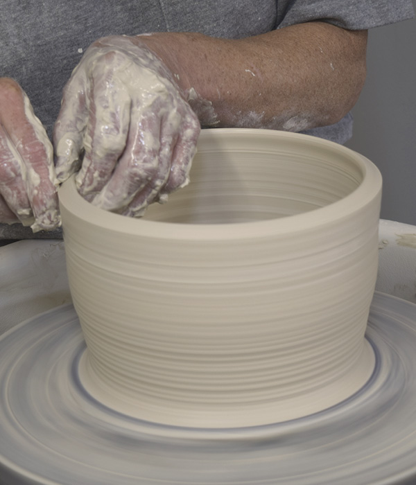 11 Using 3 pounds (1.4 kg) of clay, make another cylinder and angle the top edge outward. The top edge should match your caliper measurement again.