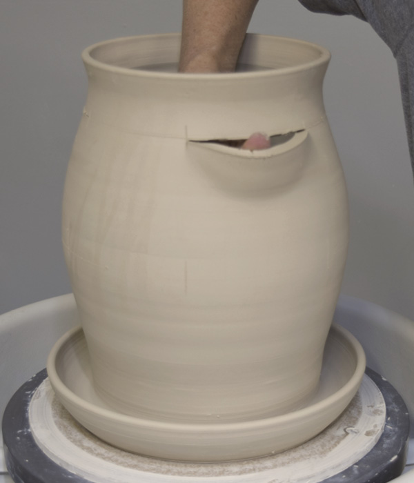 15 Use your thumb to push out the clay below each slot to create planting pockets. Reinforce the corners with a dab of clay. Use a makeup sponge to smooth the cut edges inside and out.