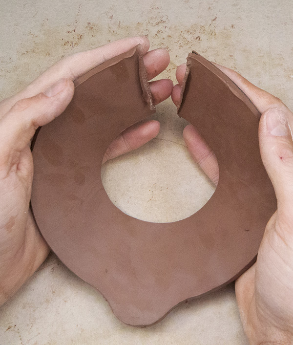 6 Gently bend the edges together with both hands supporting the slab as much as possible.