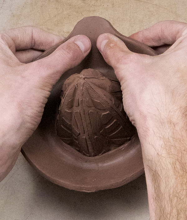 14 Gently sculpt the spout into a curved channel for liquid to pour out.
