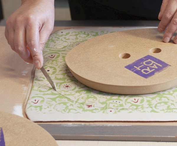 6 Place the MDF mold on the printed clay slab and roughly cut around the shape.