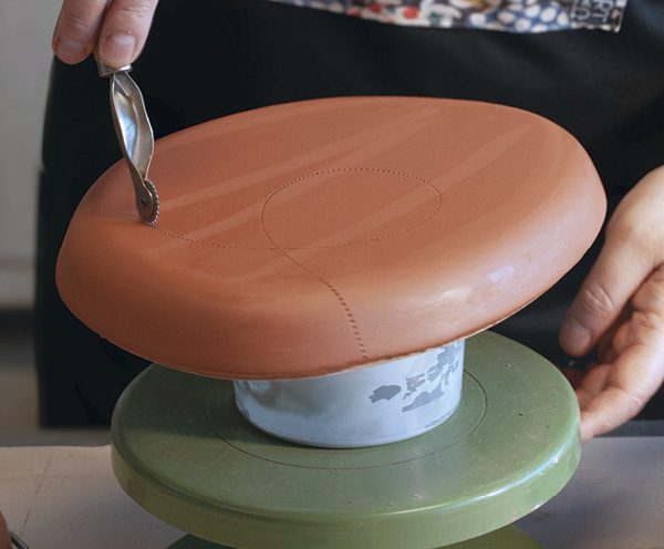 11 Apply a signature stamp and add any other decoration to the bottom of the piece.