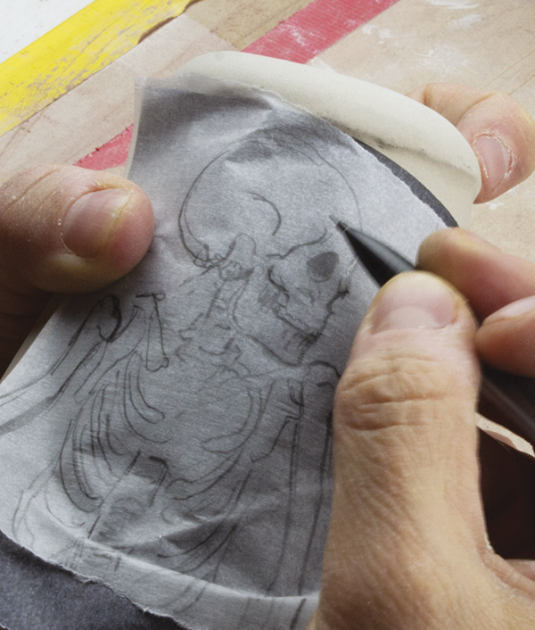 13 Once the slip is dry to the touch, transfer drawings by tracing over the image with graphite paper.