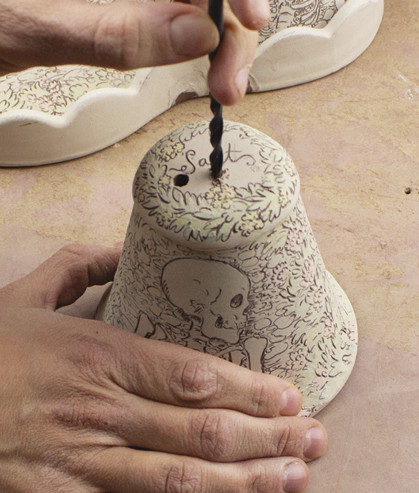 15 Once the drawings are complete, use a drill bit to make the holes on the top of the shakers.