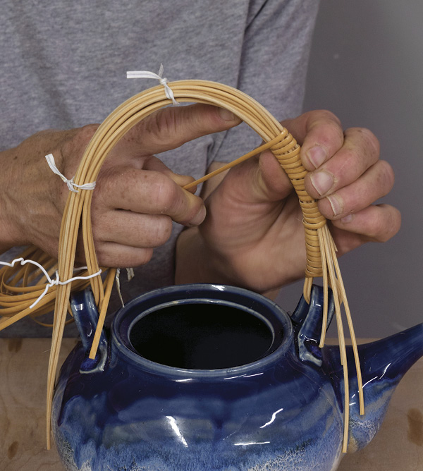 6 Continue wrapping, catching the loose pieces of the round cane under the wrapped coils, and tighten as you go.