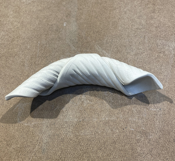 A3 Gently bend the textured and rolled square into a crescent moon shape. Keep the ends open for the next step.