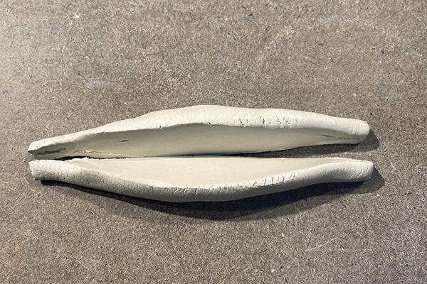 C2 Using an X-Acto knife, cut the cigar shape in half lengthwise. Smooth the cut edges of the form.