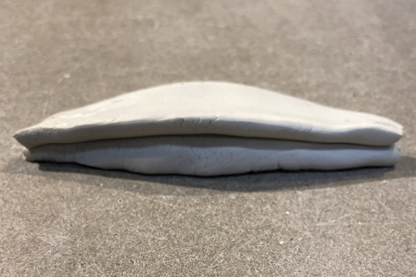 C3 Lay one section with its cut side down, then lay the rounded side of the second section on top of it lengthwise.