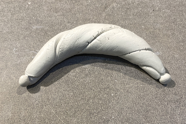 C5 Once the clay is twisted, gently roll the form on the work surface to round and soften the edges.