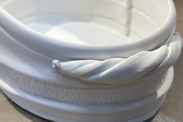 C6 Curve the twisted handle to mirror the shape of your vessel. Score and slip the vessel and handle to join them.