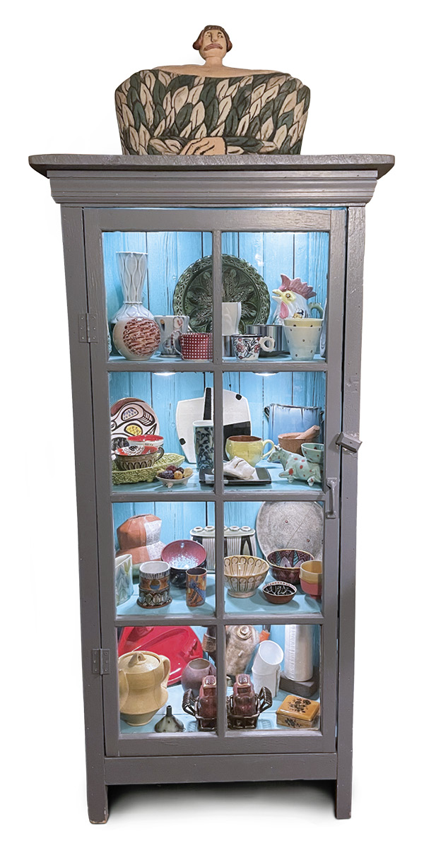 Holly Goring's glass-door cabinet, displaying her personal ceramics collection.
