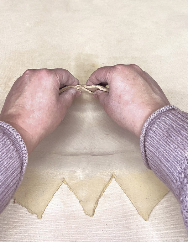 9 Score, dampen, then fold the edges up so they overlap. Repeat for all sides.