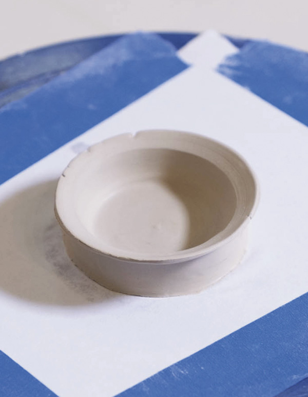 5 Spin the wheel and use a rib to make a flange about at the rim.