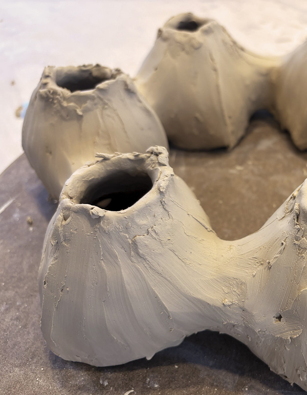 6 Pinch and blend coils with fingers to incorporate into lobe walls. Flip over.
